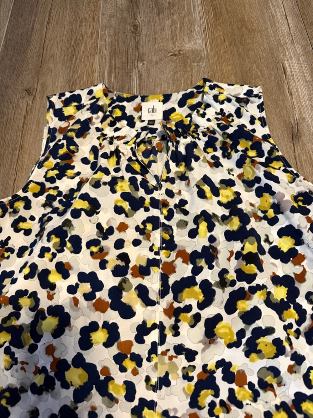 CAbi Fierce Seeing Spots sleeveless blouse featuring a colorful animal print - Picture 3 of 6